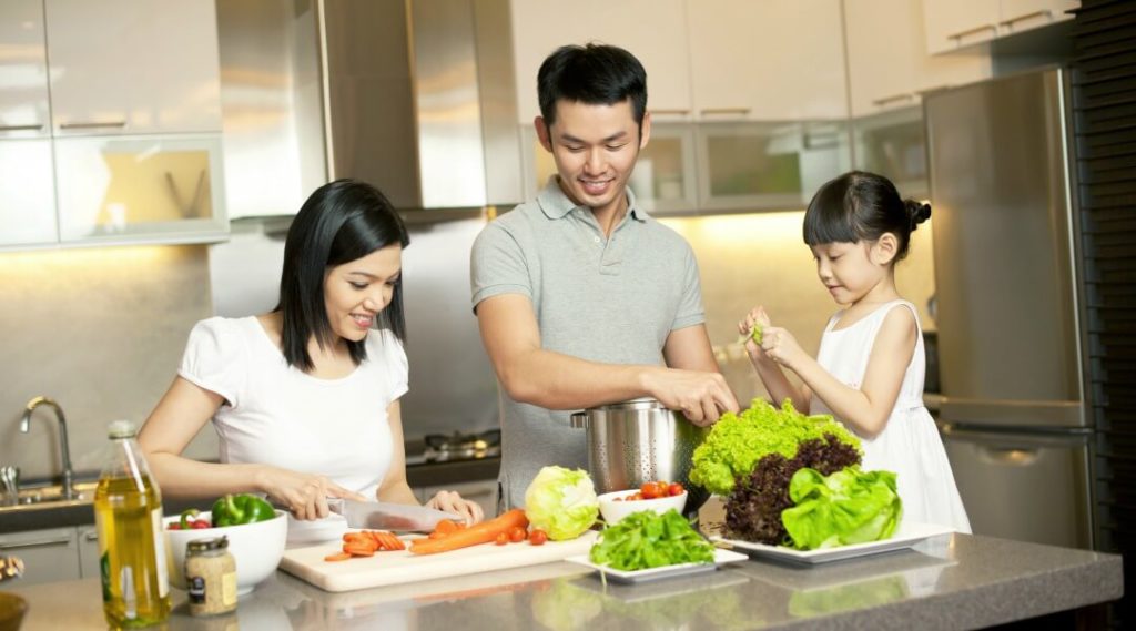 Asian family cooking in renovated kitchen